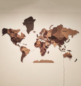 A view of our LED wooden world map on a wall in a living room, showcasing its unique and impressive design in daylight.