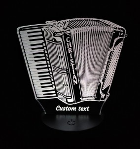 Personalized 3D LED lamp in the shape of a piano-accordion glowing in a white color, sitting on a nightstand or desk.
