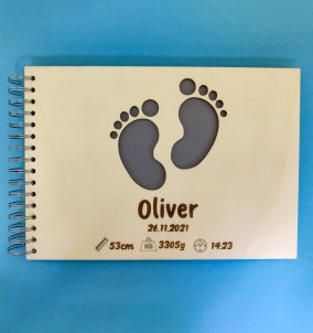 Personalized Baby Photo Album With Custom Wooden Cover. Baby's name and birthday are engraved on the cover.